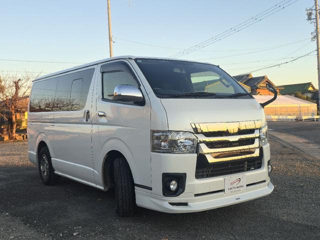 ハイエースバン ロングスーパーＧＬマルチロールトランスポータタイプＩ　ダークプライム　ディーゼルターボ　モデリスタエアロ　ＬＥＤオプションヘッドライト　リアスポイラー　パールホワイト　ハーフレザーシート　両側スライドドア　テレビ　バックカメラ　プッシュスタート　ＥＴＣ（6枚目）