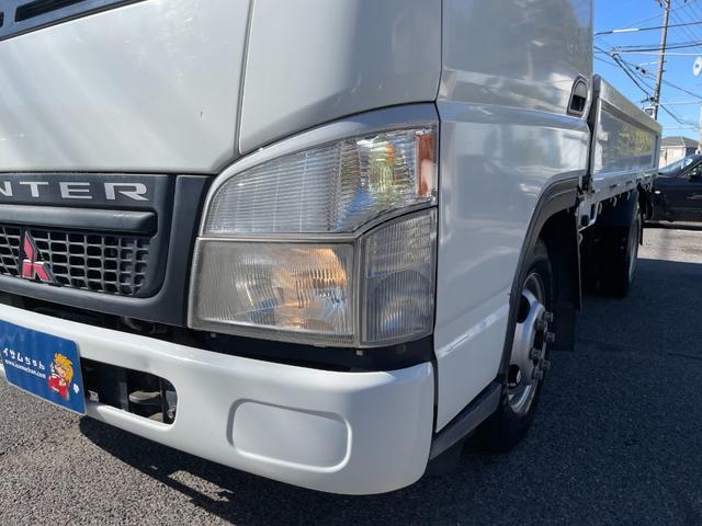 キャンターガッツ ロング全低床ＳＡ　５ＭＴ　平ボディ　荷台鉄板張り　低床　後輪ダブルタイヤ　最大積載量１５００ｋｇ　荷台サイズ　長さ３１０ｃｍ　幅１６０ｃｍ　高さ３７ｃｍ　地上高８２ｃｍ　運転席エアバック　パワーウィンドウ（18枚目）