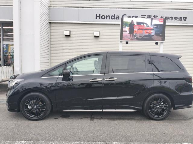 オデッセイハイブリッド ｅ：ＨＥＶアブソルート・ＥＸブラックエディション　新車　未登録車　ＥＴＣ　純正１１．４インチナビ　展示車　２列目両側アームレスト付４ウェイパワーシート　運転席＆助手席シートヒーター＋２列目シートヒーター　本革シート　１８インチアルミホイール（53枚目）