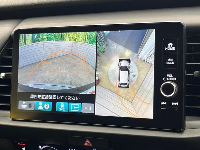 フィット ｅ：ＨＥＶリュクス　純正９型ナビ　全周囲カメラ　衝突被害軽減システム　レーダークルーズ　禁煙車　ハーフレザーシート　コーナーセンサー　スマートキー　ＬＥＤヘッド　ビルトインＥＴＣ　純正１６インチアルミ　オートハイビーム（4枚目）