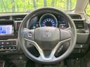 フィットハイブリッド Ｆパッケージ　禁煙車　純正ナビ　バックカメラ　Ｂｌｕｅｔｏｏｔｈ再生　ＥＴＣ　ドライブレコーダー　スマートキー　オートエアコン　革巻きステアリング　ステアリングスイッチ　１５インチアルミホイール　地デジ　ＤＶＤ再生（8枚目）