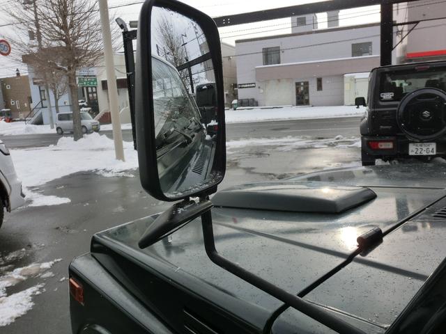 ジムニー ワイルドウインドリミテッド　タニグチ前後バンパー・タニグチ２ＵＰシャックル公認・ＣＤ・グリーンツートン・革調シートカバー・革調内張・ウッドハンドル・夏ブロックタイヤ付純正ホイール・冬２０２４製ＢＳスタッドレス・クリスタルライト（24枚目）