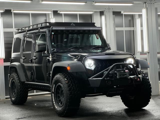 ジープ・ラングラーアンリミテッド スポーツ リフトアップ/マッドタイヤ/社外バンパー/社外グリル/社外ヘッドライト/サイドマーカー/サイドステップ/ルーフラック/テールガード/アルパインフローティングナビTV/バックカメラ/ETC車載器(5枚目)