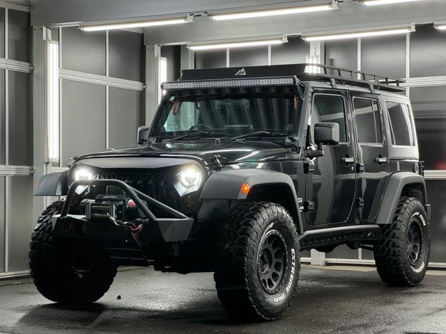 ジープ・ラングラーアンリミテッド スポーツ リフトアップ/マッドタイヤ/社外バンパー/社外グリル/社外ヘッドライト/サイドマーカー/サイドステップ/ルーフラック/テールガード/アルパインフローティングナビTV/バックカメラ/ETC車載器(6枚目)