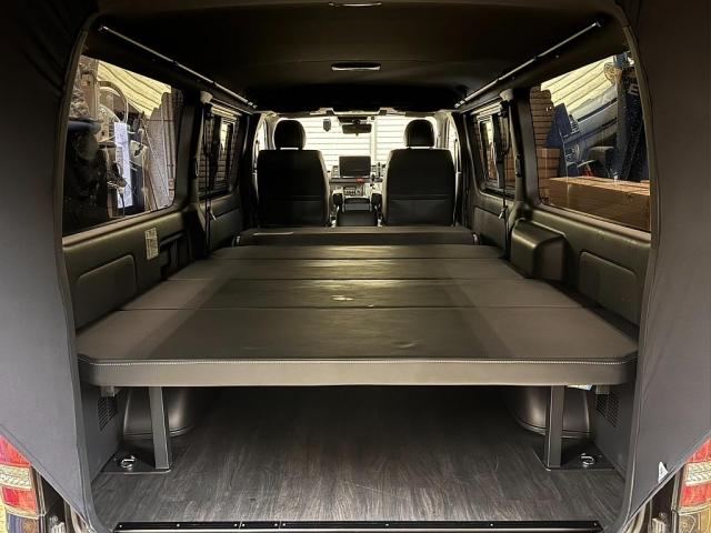 ハイエースバン スーパーＧＬ　ダークプライムＩＩ　デジタルインナーミラー　パノラミックビューモニター　寒冷地仕様　スポイラー　テールランプ　アルミ　タイヤ　１．５ｉｎローダウン　ＢＩＧ－Ｘナビメカレス　後席モニター　ＥＴＣ　フローリング　ベットキット（4枚目）