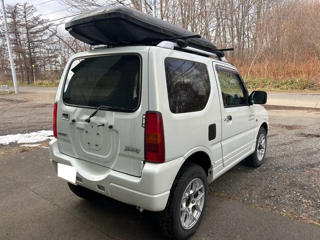 ジムニー ＦＩＳフリースタイルワールドカップリミテッド　４ＷＤ　ナビ　テレビ　ＥＴＣ　ターボタイマー　夏冬タイヤ　スペアキー　曇止め用ヒーター機能付ドアミラー　シートヒーター　ルーフキャリア（8枚目）