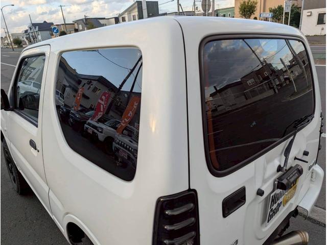 ジムニー XG MT車・後期・リフトアップ・社外テール・社外マフラー・ナンバー移設・社外AW・フォグランプ・ライトレベライザー・ナビ・地デジTV・切替4WD・エアコン・下廻り防錆処理・車検整備付(37枚目)