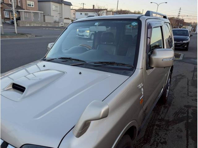 ジムニー ワイルドウインド AT車 社外テール ナビ フォグランプ ハーフレザーシート ドアサイドバイザー 電動格納ミラー ルーフレール スペアタイヤカバー(31枚目)