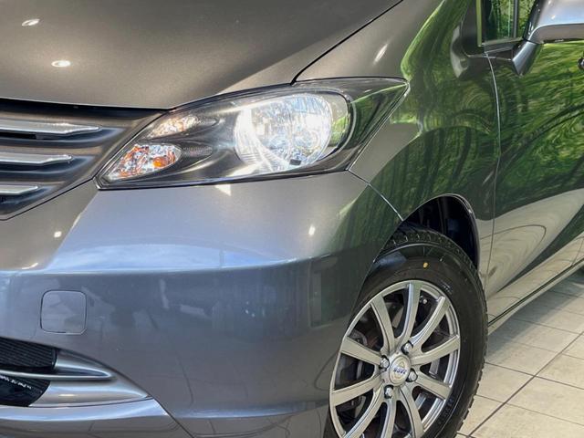 フリード G ジャストセレクション 両側電動ドア 純正HDDナビ バックカメラ 禁煙車 スマートキー HIDヘッド ETC オートライト オートエアコン CD/DVD再生 14インチアルミホイール 電動格納ミラー ドアバイザー(14枚目)