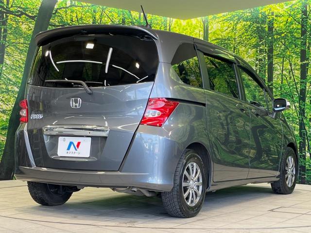 フリード G ジャストセレクション 両側電動ドア 純正HDDナビ バックカメラ 禁煙車 スマートキー HIDヘッド ETC オートライト オートエアコン CD/DVD再生 14インチアルミホイール 電動格納ミラー ドアバイザー(18枚目)