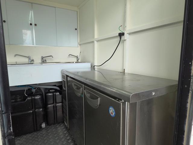 キャリイトラック 移動販売車 キッチンカー ケータリングカー フードトラック 3槽シンク 100L給排水タンク 冷凍冷蔵コールドテーブル 換気扇 照明 扉付きバンク収納 外部電源 跳上扉 アクリル窓 カウンター(4枚目)