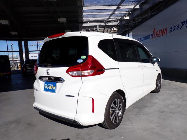 フリード+ハイブリッド ハイブリッドG・ホンダセンシング Cパッケージ 9インチプレミアムインターナビ フルセグTV バックカメラ ビルトインETC ナビ連動前後ドライブレコーダー シートヒーター 両側パワースライドドア LEDヘッドランプ(4枚目)