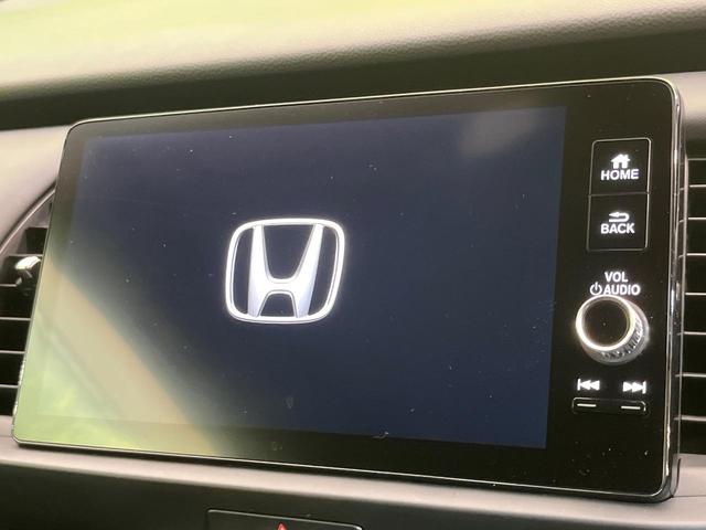 フィット e:HEVホーム 純正9型ナビ バックカメラ ホンダセンシング 禁煙車 ハーフレザーシート コーナーセンサー スマートキー LEDヘッド ETC2.0 車線逸脱警報 オートライト オートエアコン 電動格納ミラー(3枚目)