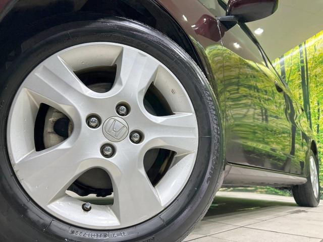 フィット X 純正ナビ バックカメラ クルーズコントロール 禁煙車 HIDヘッド ETC オートライト オートエアコン 純正15インチAW CD/DVD再生 地デジ ドアバイザー 電動格納ミラー 革巻きステアリング(13枚目)