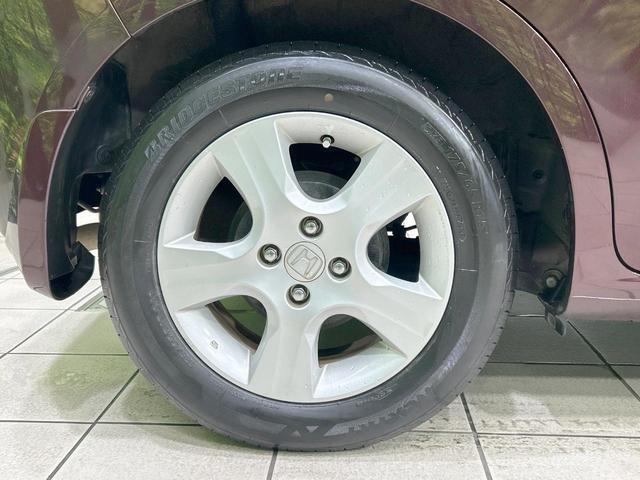 フィット X 純正ナビ バックカメラ クルーズコントロール 禁煙車 HIDヘッド ETC オートライト オートエアコン 純正15インチAW CD/DVD再生 地デジ ドアバイザー 電動格納ミラー 革巻きステアリング(28枚目)