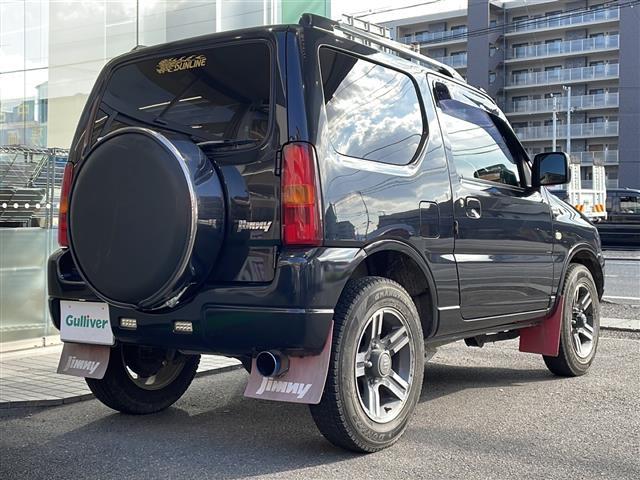ジムニー ワイルドウインド ロッソモデロマフラー・社外ナビ・ターボ・4WD・前後ドラレコ・ETC・シートヒーター・背面タイヤ(27枚目)