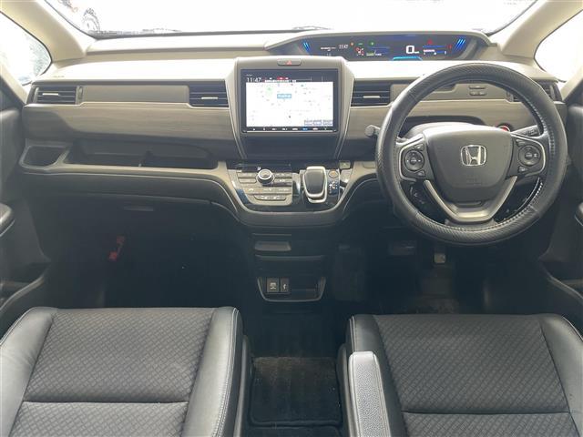 フリードハイブリッド ハイブリッド・Ｇホンダセンシング　純正９型メモリナビ　フルセグ　ＤＶＤ再生　Ｂｌｕｅｔｏｏｔｈ接続　後席用モニター　バックカメラ　前後ドラレコ　ＥＴＣ　ＡＣＣ　両パワスラ　コーナーセンサー　シートヒーター　スマートキー　社外１７ＡＷ（2枚目）