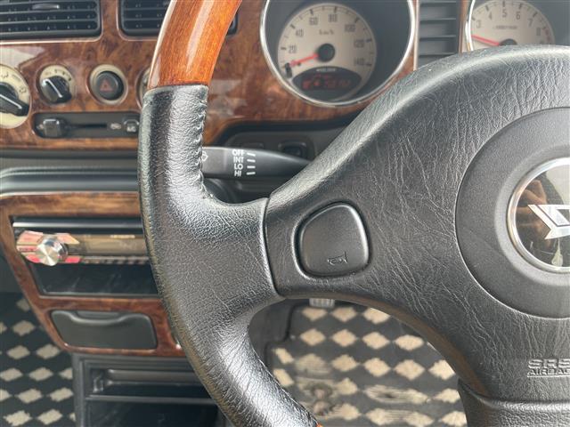 ミラジーノ ジーノ　禁煙車　５速ＭＴ　社外オーディオ　ＥＴＣ　ブラウンウッドインテリア　ウッドコンピステアリング　ハーフレザーシート　電動格納ミラー　メカニカルキー　スペアキー　純正ホイールカバー　取扱説明書　保証書（6枚目）