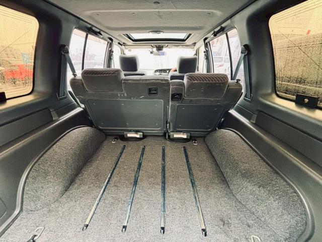 ビッグホーン ハンドリングバイロータス　ロング　ユーザー様直接仕入　サンルーフ　ガナドールマフラー　インチアップ　社外１６ＡＷ　Ａ／Ｔタイヤ　ルーフスポイラー　サイドステップ　社外ナビ　フルセグＴＶ　バックカメラ　シートヒーター　スペアキー　ＥＴＣ（64枚目）