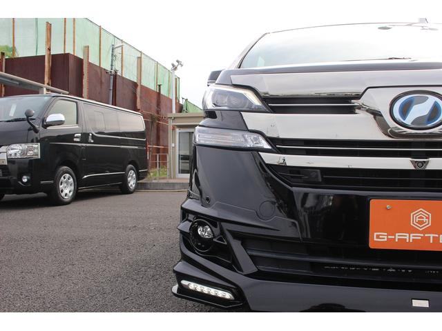 ヴェルファイアハイブリッド エグゼクティブラウンジ 禁煙車 フロントTRDエアロ サイド、リアモデリスタエアロ 純正10.5型JBLナビ 黒革シート 全周囲カメラ 後席モニター シートヒーター 衝突軽減ブレーキ パワーシート スマートキー(14枚目)