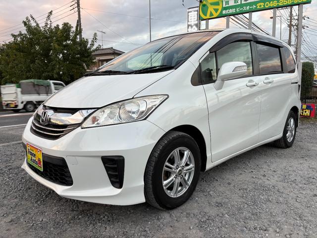 フリード Ｇ　ジャストセレクション　平成２７年式　走行距離５７０００キロ　ナビ　バックカメラ　ワンセグＴＶ　両側電動スライドドア　Ｂｌｕｅｔｏｏｔｈオーディオ　ＥＴＣ　スマートキー　社外アルミ　３列シート６人乗り（7枚目）