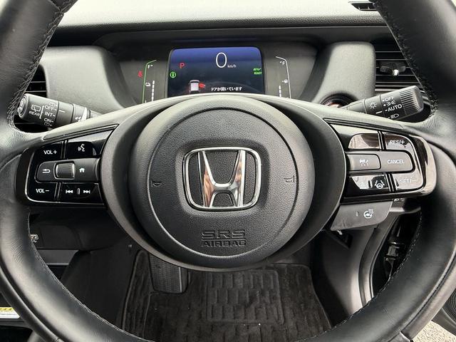 フィット ｅ：ＨＥＶリュクス　フルセグナビ・Ｓ＆Ｂカメラ・ＢＴオーディオ・ＬＥＤライト・ＡＣＣ・ＬＫＡ・ＡＨＢ・Ｃソナー・ハーフレザー・本革ステア・ミラーウィンカー・ドアバイザー・ＥＴＣ２．０・スマキー・１６ＡＷ（23枚目）