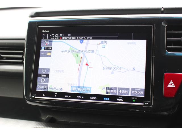 ステップワゴンスパーダ スパーダホンダセンシング　ＥＴＣ２．０　ＨｏｎｄａＳＥＮＳＩＮＧ　わくわくゲート　１６インチアルミ　ＦＡＢＴＥＣＴ撥水撥油シート大画面ナビ　バックカメラ　パドルシフト　スマートキー　７人乗り　フォグライト　両側電動スライド（3枚目）