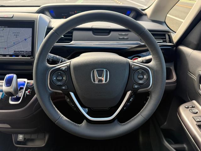 フリードハイブリッド ハイブリッド・モデューロX ホンダセンシング 6人乗り 禁煙1オーナー車 純正9型ナビ 両側電動スライド バックカメラ ETC2.0 衝突軽減装置 車線逸脱警報 Bluetoothオーディオ フルセグTV DVD再生 ハーフレザー 追従クルコン(31枚目)