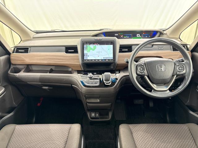 フリードハイブリッド ハイブリッド・Ｇホンダセンシング　ワンオーナー　禁煙車　純正９インチナビ　フルセグテレビ　Ｂｌｕｅｔｏｏｔｈ　ミュージックサーバー　ＵＳＢ　リア席モニター　前後ドラレコ　ＥＴＣ　両側電動スライドドア　シートヒーター　ＬＥＤヘッドライト（12枚目）