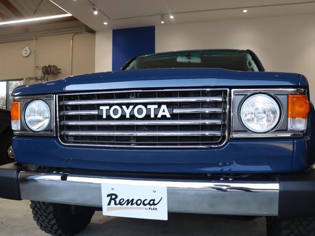 ランドクルーザー１００ ＶＸリミテッド　Ｇセレクション　再販７０純正ブルー　グレードＧセレクション　サンルーフ　丸目ヘッドライト換装　ＤＥＡＮ　カリフォルニアホイール　オープンカントリー２３５／８５／１６ＭＴ　ｃａｒｒｏｚｚｅｒｉａ７インチフルセグナビ搭載（22枚目）