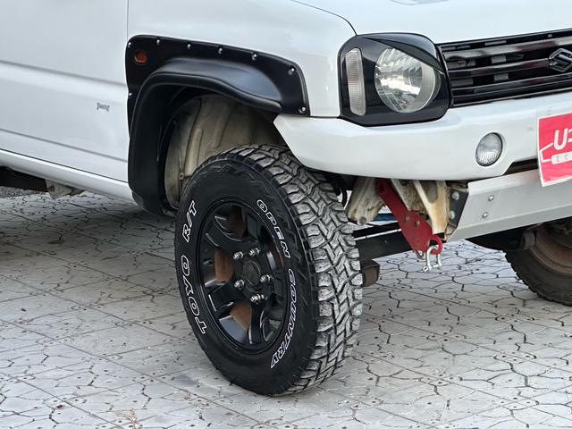 ジムニー Ｊ２　【１年間走行無制限保証】／ＴＡＮＩＧＵＣＨＩコンプリート車両（エアロ・マフラー・スキッドプレート・リフトアップ）／ブリスターフェンダー／ＬＥＤテール／１６インチ／ラギッドテレーン（ＴＯＹＯ）（16枚目）