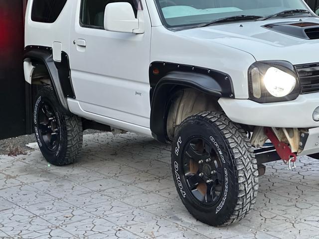 ジムニー Ｊ２　【１年間走行無制限保証】／ＴＡＮＩＧＵＣＨＩコンプリート車両（エアロ・マフラー・スキッドプレート・リフトアップ）／ブリスターフェンダー／ＬＥＤテール／１６インチ／ラギッドテレーン（ＴＯＹＯ）（19枚目）