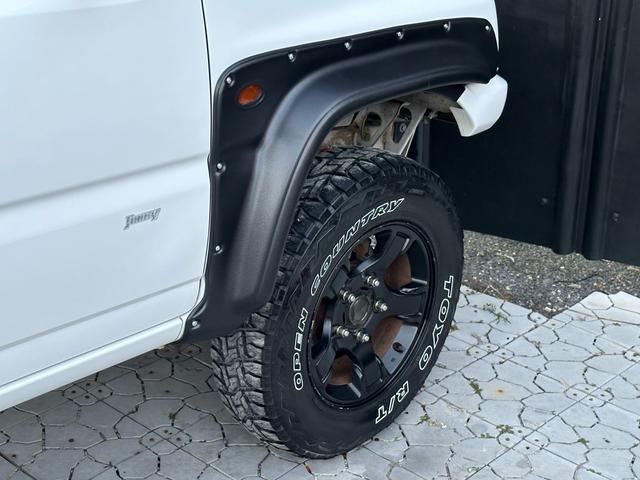 ジムニー Ｊ２　【１年間走行無制限保証】／ＴＡＮＩＧＵＣＨＩコンプリート車両（エアロ・マフラー・スキッドプレート・リフトアップ）／ブリスターフェンダー／ＬＥＤテール／１６インチ／ラギッドテレーン（ＴＯＹＯ）（59枚目）