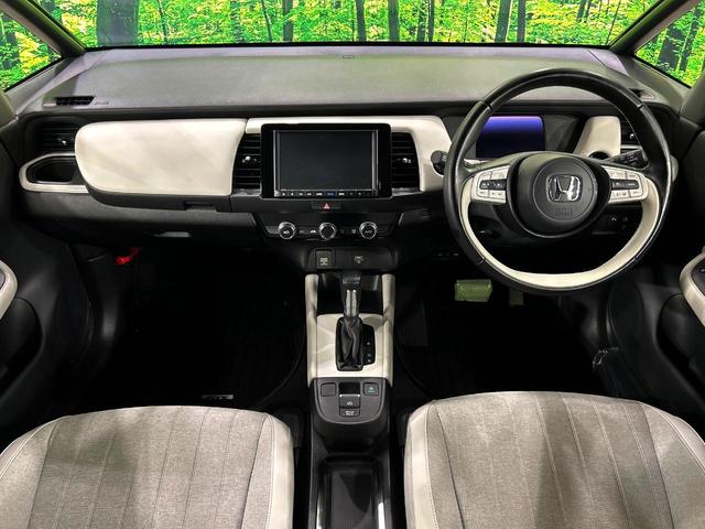 フィット e:HEVホーム 純正8インチナビ バックカメラ ホンダセンシング アダプティブクルーズ 禁煙車 ハーフレザーシート スマートキー LEDヘッド ETC オートライト CD・DVD再生 Bluetooth(2枚目)