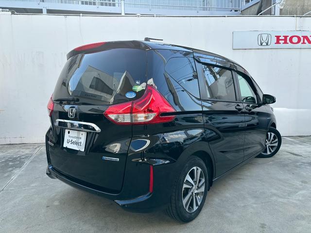 フリードハイブリッド ハイブリッド・Ｇホンダセンシング　ＡＣＣフルセグナビＬＥＤヘッドＲカメラＥＴＣサイドカーテンエアバッグＲモニター両側パワスラ運転席助手席シートヒーターＢＴミュージックラックＣＤＤＶＤ再生純正アルミ本革巻きステアリングスマキー（4枚目）