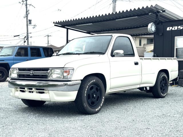 ハイラックス ＤＸ　ＲＺＮ１４７　ＮＯｘ・ＰＭ適合　ローダウン　ＴＯＹＯ　Ｈ２Ｏホワイトレタータイヤ　ＭＬＪ　Ｄ：ＳＬＯＴ１６インチアルミＪＷＬ－Ｔ　社外サイド出しマフラー　シートカバー　ＵＳステップバンパー（5枚目）