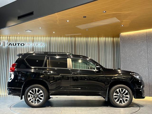 ランドクルーザープラド TX Lパッケージ ムーンルーフ/ブラックルーフレール/19インチ純正アルミホイール/モデリスタ フロントスポイラー/モデリスタ リアスカート/モデリスタリアスポイラー/純正OPウッド調ステアリング/アルパインナビ(10枚目)