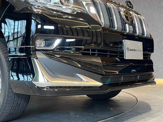 ランドクルーザープラド TX Lパッケージ ムーンルーフ/ブラックルーフレール/19インチ純正アルミホイール/モデリスタ フロントスポイラー/モデリスタ リアスカート/モデリスタリアスポイラー/純正OPウッド調ステアリング/アルパインナビ(25枚目)