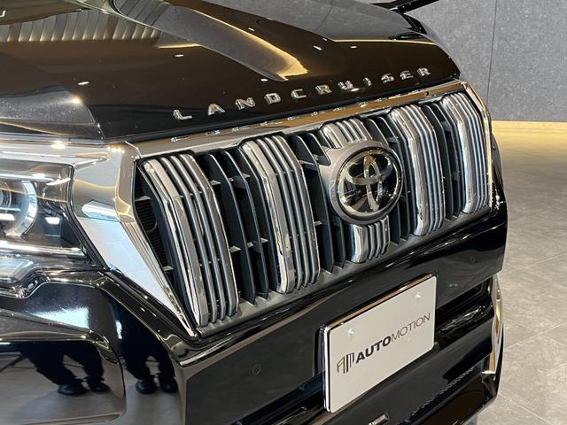 ランドクルーザープラド TX Lパッケージ ムーンルーフ/ブラックルーフレール/19インチ純正アルミホイール/モデリスタ フロントスポイラー/モデリスタ リアスカート/モデリスタリアスポイラー/純正OPウッド調ステアリング/アルパインナビ(26枚目)