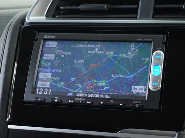 フィットハイブリッド Fパッケージ 1オ-ナ-ナビRカメETCワンセグBT接続DVD 盗難警報装置 ワンオ-ナ-車 AUTOエアコン 助手席エアバック ECON ETC付き リヤカメラ USB ABS付 DVD視聴 横滑り防止システム(3枚目)