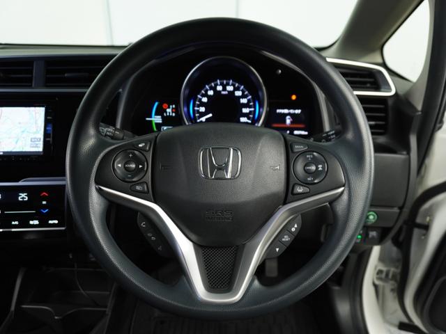 フィットハイブリッド F 1オ-ナ-ナビRカメETCクルコンBT地デジ 地デジTV ナビTV リアカメラ 横滑り防止装置 フルオートエアコン イモビライザー キーフリーシステム 全席パワーウインドウ パワーステアリング ABS(9枚目)