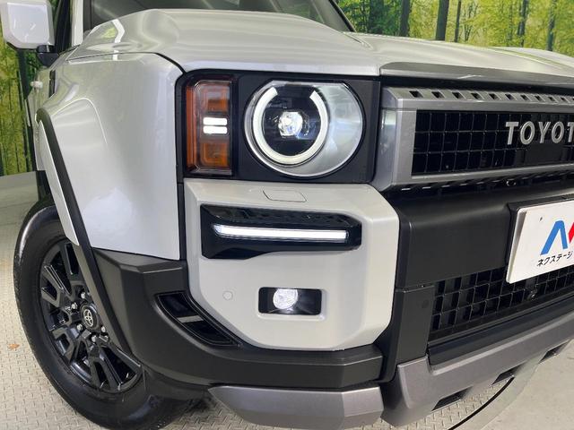 ランドクルーザー２５０ ＶＸ　モデリスタ　ムーンルーフ　純正１２．３型ナビ　ＯＰ１眼ＬＥＤ　７人乗り　全周囲カメラ　黒革　ＢＳＭ　禁煙車　電動リアゲート　ルーフレール　デジタルミラー　シートベンチレーション（14枚目）