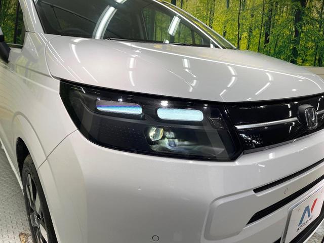 フリード エアー EX 登録済未使用車 両側電動ドア ホンダセンシング レーダークルーズ コーナーセンサー スマートキー LEDヘッド オートハイビーム 車線逸脱警報 オートライト オートエアコン 純正15インチアルミ(13枚目)