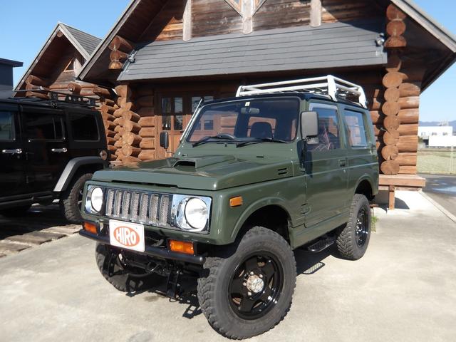 ジムニー ワイルドウインドリミテッド　リフトアップ公認・社外Ｆ＆Ｒバンパー・純正メッキグリル・純正ルーフキャリア・赤ステッチレザーシートカバー・タニグチ製ステップバー・社外ステアリング・純正１６インチＡＷ・Ｍ／Ｔタイヤ・天井ウッド張替（2枚目）