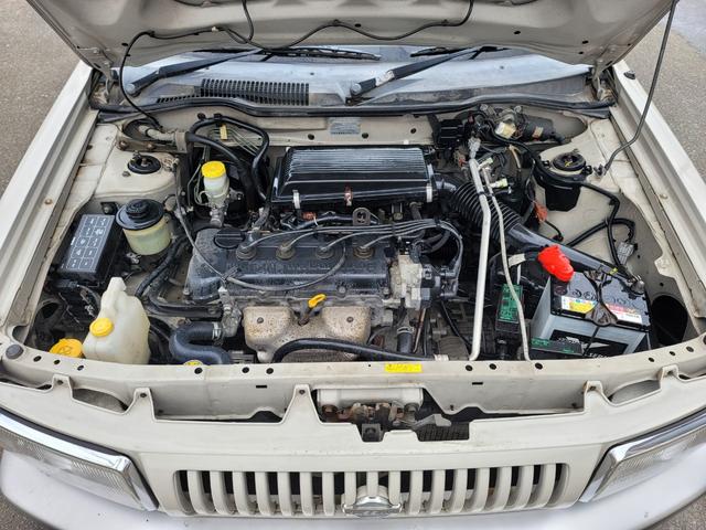 ラシーン タイプＭ　最終型　特別仕様車　羅針盤デザインシート　木目調パネル　背面タイヤ＆ハードカバー　ルーフレール　ＥＴＣ　タイミングチェーン式　キーレス　ＣＤステレオ　４ＷＤ　日産ディーラー仕入れ（5枚目）