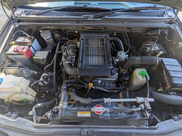 ジムニー クロスアドベンチャーＸＣ　４ＷＤ　８型５ＭＴ　ＳＤナビ　ＨＫＳ社外マフラー　ハーフレザーシート　シートヒーター　革巻ハンドル　背面タイヤカバー　純正１６ＡＷ　フォグライト　キーレス　ターボ　パワーウィンドウ　ミラーヒーター　電格ミラー　光軸調整ライト（21枚目）