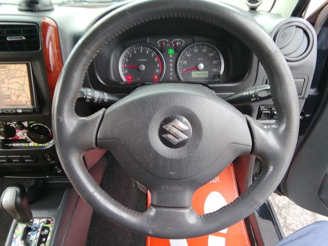 ジムニー ランドベンチャー　４ＷＤ切替　リフトアップ　ＨＤＤナビ　ワンセグＴＶ　ＣＤ／ＤＶＤ再生　社外１６インチＡＷ　フォグランプ　ハードカバー付き背面タイヤ　ハーフレザーシート　電動格納ミラー　ライトレベライザー　エアコン（8枚目）