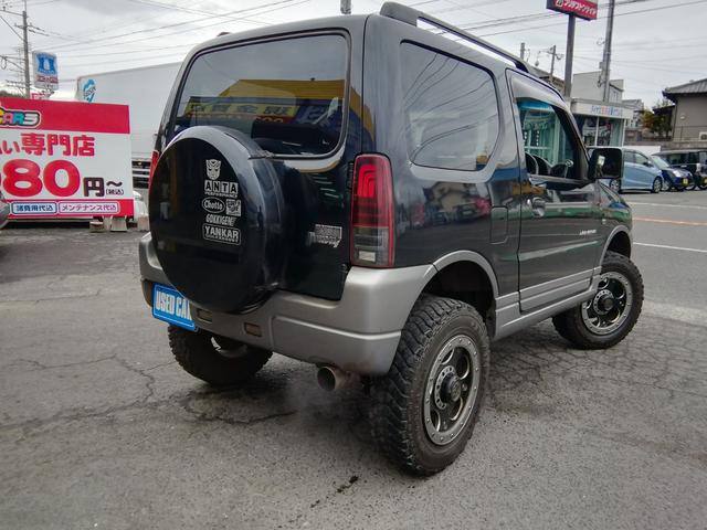 ジムニー ランドベンチャー　４ＷＤ切替　リフトアップ　ＨＤＤナビ　ワンセグＴＶ　ＣＤ／ＤＶＤ再生　社外１６インチＡＷ　フォグランプ　ハードカバー付き背面タイヤ　ハーフレザーシート　電動格納ミラー　ライトレベライザー　エアコン（10枚目）