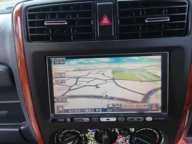 ジムニー ランドベンチャー　４ＷＤ切替　リフトアップ　ＨＤＤナビ　ワンセグＴＶ　ＣＤ／ＤＶＤ再生　社外１６インチＡＷ　フォグランプ　ハードカバー付き背面タイヤ　ハーフレザーシート　電動格納ミラー　ライトレベライザー　エアコン（20枚目）