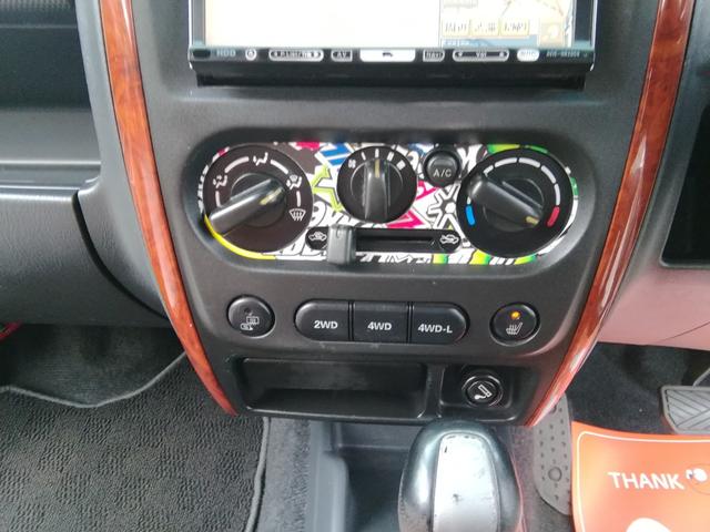 ジムニー ランドベンチャー　４ＷＤ切替　リフトアップ　ＨＤＤナビ　ワンセグＴＶ　ＣＤ／ＤＶＤ再生　社外１６インチＡＷ　フォグランプ　ハードカバー付き背面タイヤ　ハーフレザーシート　電動格納ミラー　ライトレベライザー　エアコン（22枚目）